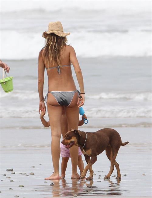 A pregnant Gisele Bundchen walking on the beach in Costa Rica with - July 23, 2012.  She is pregnant with her second child.