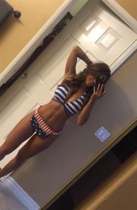Tianna Gregory in a bikini taking a selfie