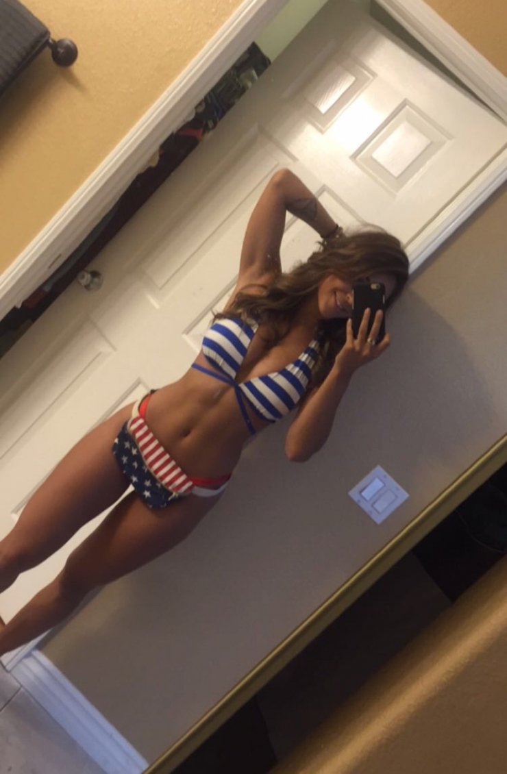 Tianna Gregory in a bikini taking a selfie