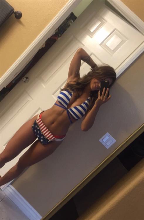 Tianna Gregory in a bikini taking a selfie