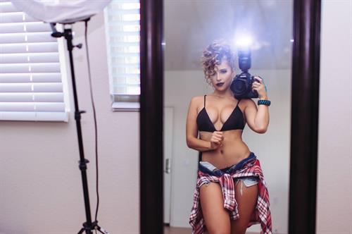 Tianna Gregory in a bikini taking a selfie