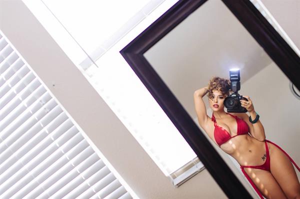 Tianna Gregory in a bikini taking a selfie