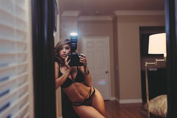 Tianna Gregory in a bikini taking a selfie