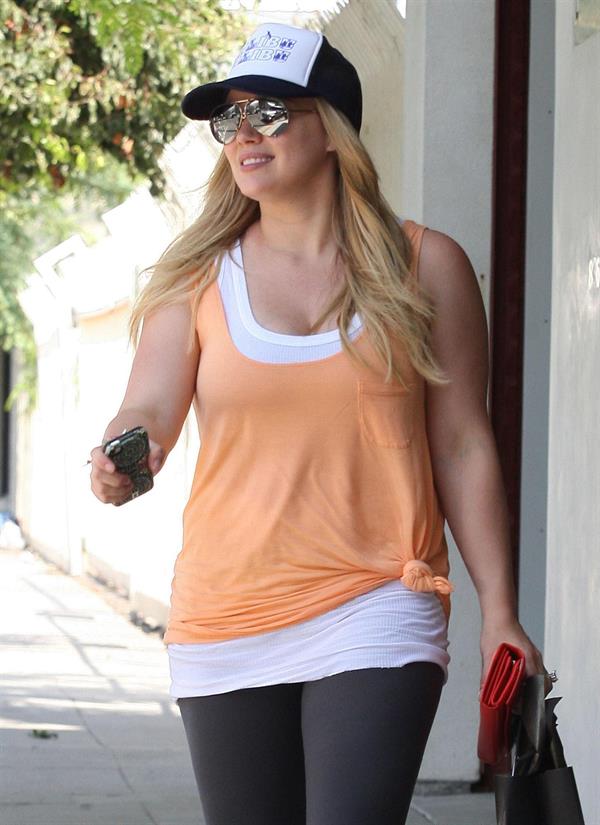 Hilary Duff Out in Los Angeles, August 30, 2012.  She's wearing a baseball cap and orange shirt as she leaves her personal trainers house