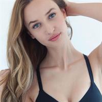 Ariane Fournier in a bikini taking a selfie