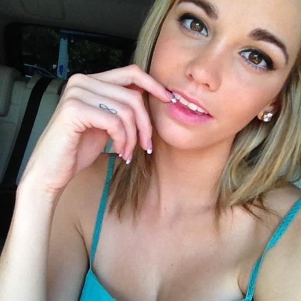 Caitlin Arnett in a bikini taking a selfie