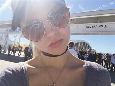 Dove Cameron taking a selfie