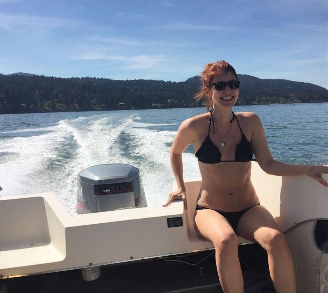 Jewel Staite in a black bikini