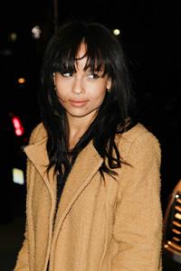 Zoe Kravitz in a long jacket and high heels