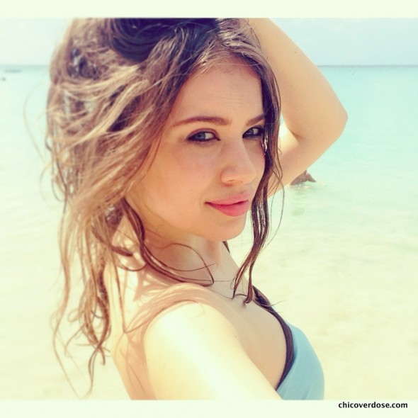 Xenia Tchoumitcheva in a bikini taking a selfie