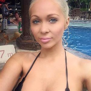 Krystal Dawson in a bikini taking a selfie