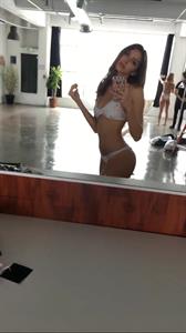 Celine Farach in a bikini taking a selfie
