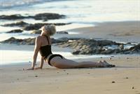 Miley Cyrus  yoga in black bikini on beach in Hawaii 1/24/13 