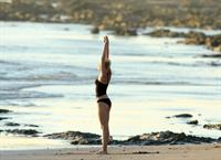 Miley Cyrus  yoga in black bikini on beach in Hawaii 1/24/13 