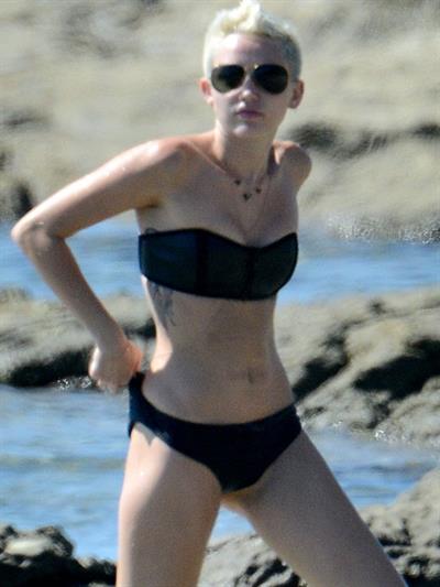 Miley Cyrus  yoga in black bikini on beach in Hawaii 1/24/13 