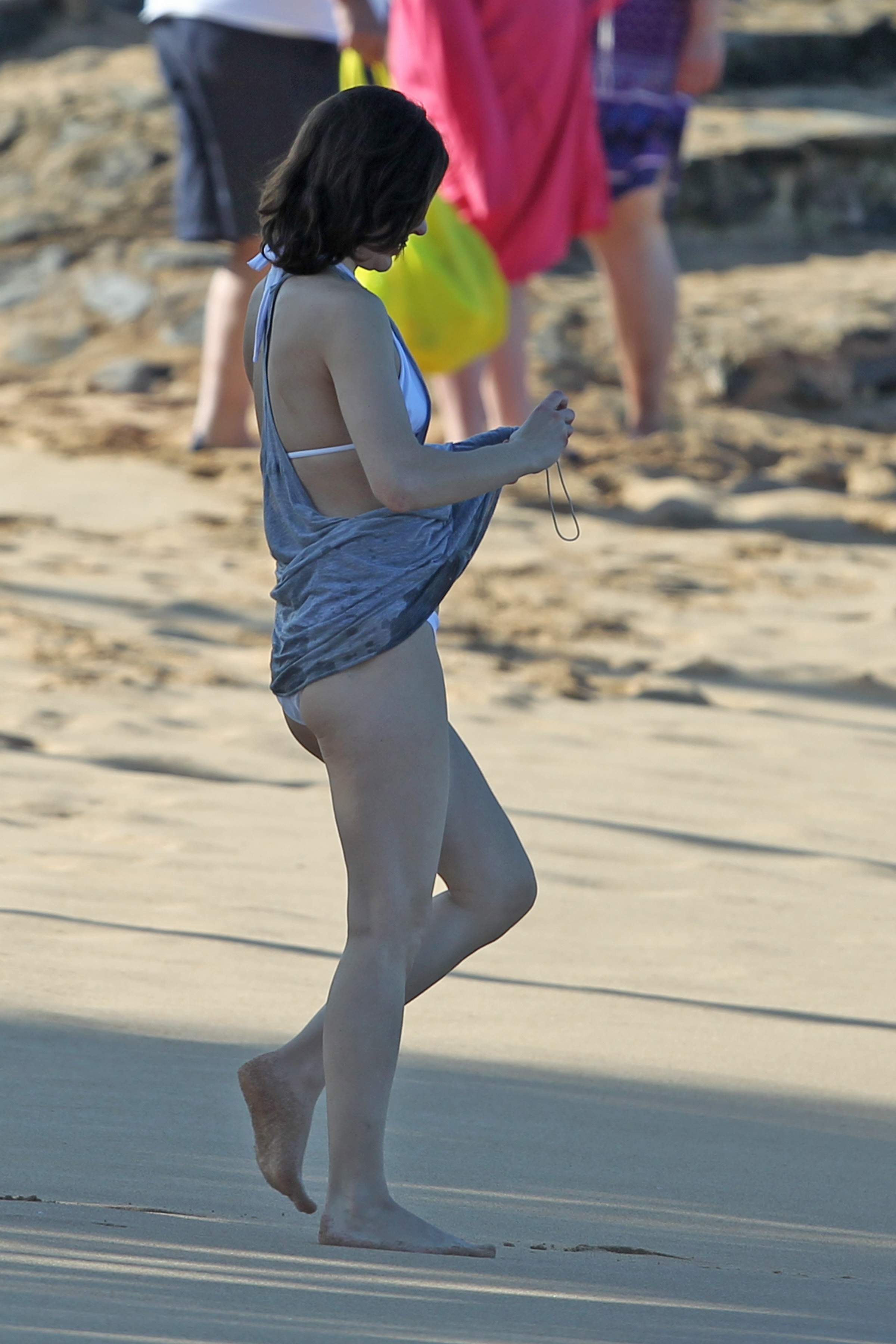 Milla Jovovich on the beach in a bikini on New Years Eve in Maui, Hawaii De...