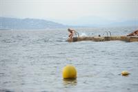 Kimberley Garner in a black bikini on the beach in St. Tropez on July 31, 2014