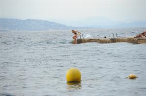 Kimberley Garner in a black bikini on the beach in St. Tropez on July 31, 2014