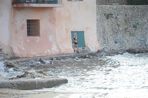 Kimberley Garner in a black bikini on the beach in St. Tropez on July 31, 2014
