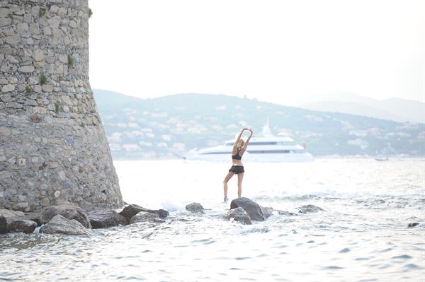Kimberley Garner in a black bikini on the beach in St. Tropez on July 31, 2014
