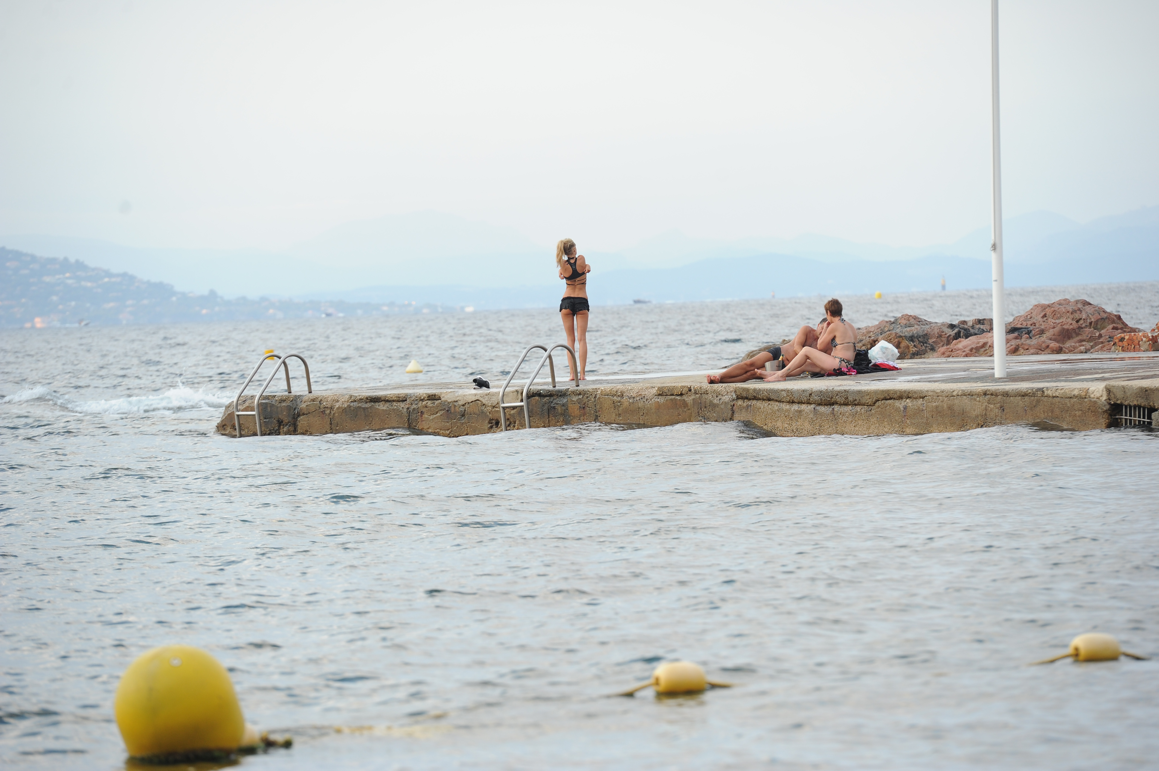 Kimberley Garner in a black bikini on the beach in St. Tropez on July 31, 2014