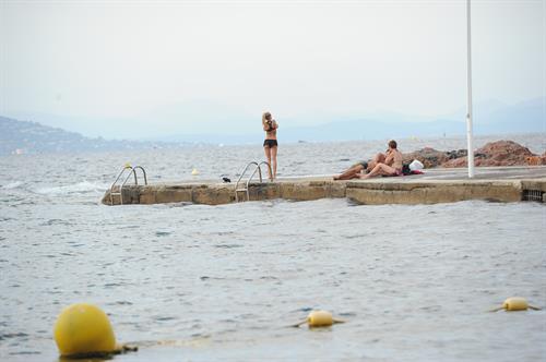 Kimberley Garner in a black bikini on the beach in St. Tropez on July 31, 2014