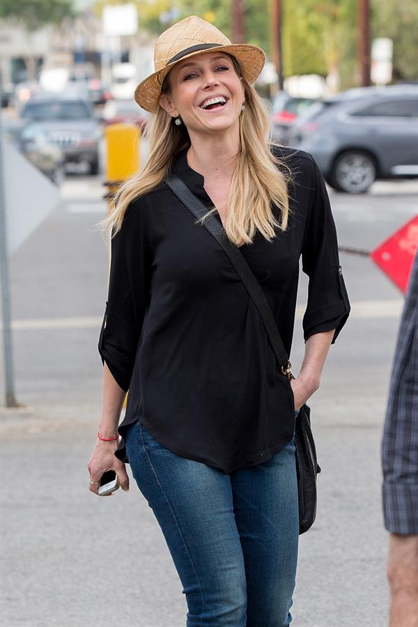 Julie Benz walking in jeans and a hat