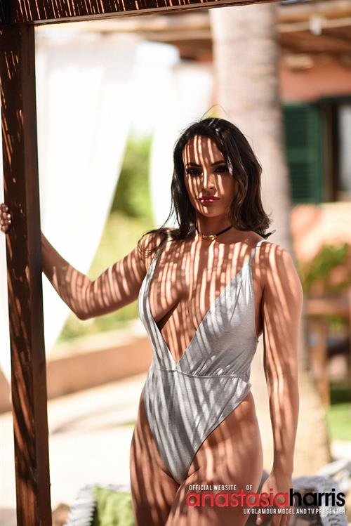 Anastasia in her grey bodysuit by the pool