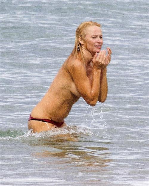 Pamela Anderson Pamela Anderson Going topless at the beach in France 02.10.13