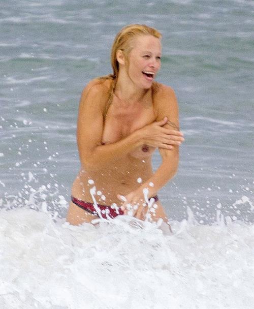 Pamela Anderson Pamela Anderson Going topless at the beach in France 02.10.13