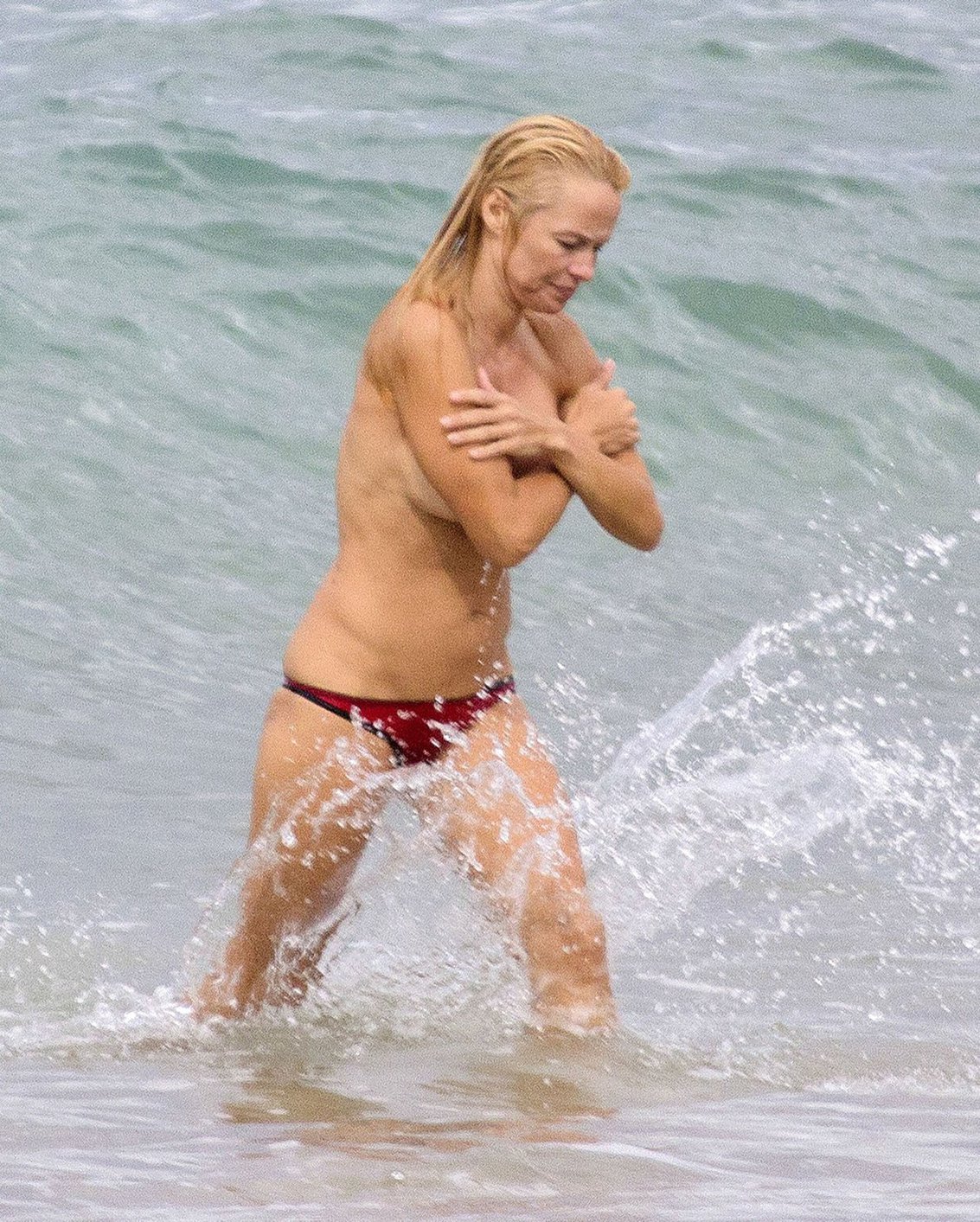 Pamela Anderson Pamela Anderson Going topless at the beach in France 02.10.13