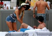 Paris Hilton spends the day in and out of the pool in Miami December 8, 2012
