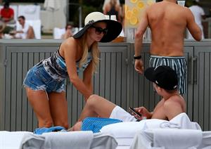 Paris Hilton spends the day in and out of the pool in Miami December 8, 2012