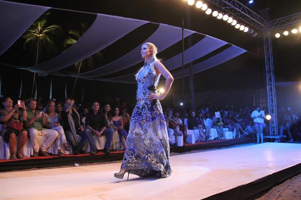 Paris Hilton walks for designer duo Shane and Falguni Peacock and performs as a DJ at the India Resort Fashion Week