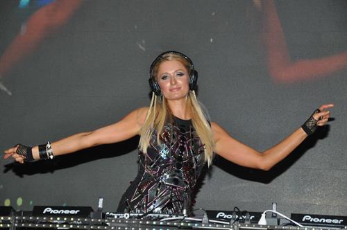 Paris Hilton walks for designer duo Shane and Falguni Peacock and performs as a DJ at the India Resort Fashion Week