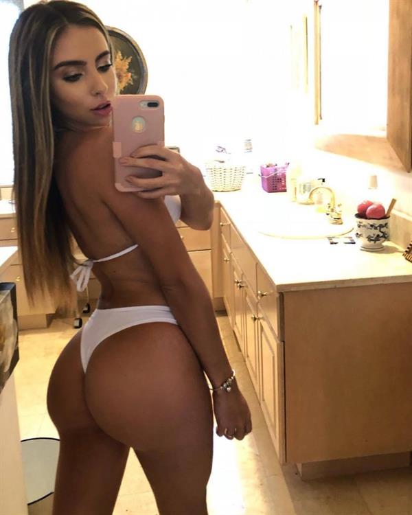 Bruna Lima in a bikini taking a selfie and - ass