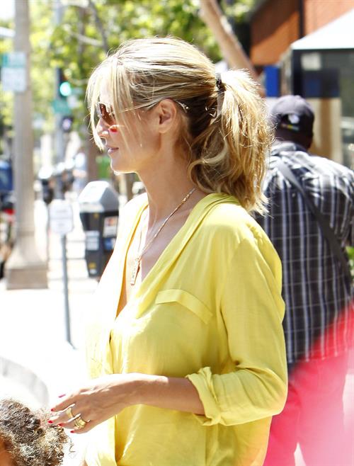 Heidi Klum out for lunch in Brentwood in a yellow shirt
