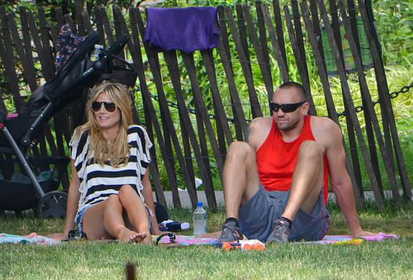 Heidi Klum in a black and white striped shirt, spends a day out in a park in Tribeca on June 30, 2013 