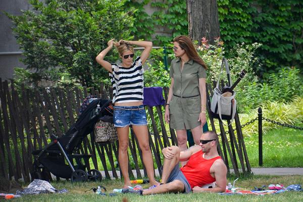 Heidi Klum in a black and white striped shirt, spends a day out in a park in Tribeca on June 30, 2013 