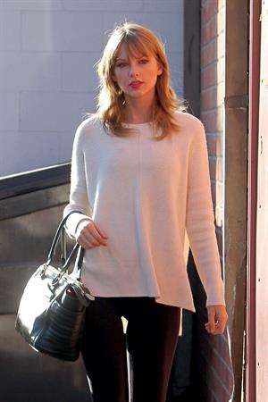 Taylor Swift wearing a white top and black pants in Los Angeles 10/28/13  