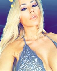 Kindly Myers in a bikini taking a selfie