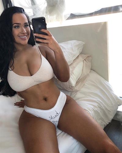 Sarah MacDonald in a bikini taking a selfie