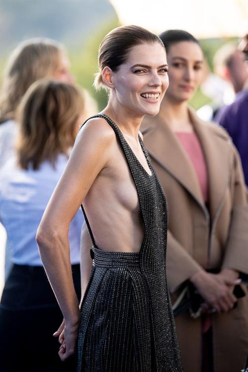 Emma Greenwell Pictures Emma Greenwell braless side boob in a dress at the premiere of The Rook .