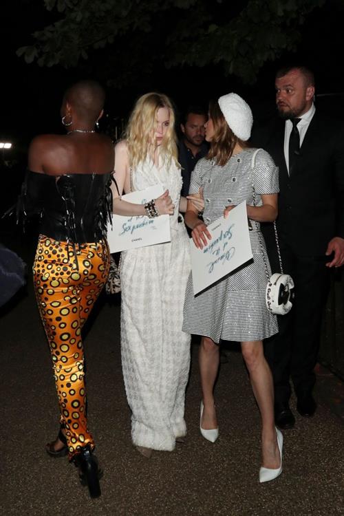 Ellie Bamber Pictures Ellie Bamber braless boobs while wearing basically a scarf as a top showing side boob cleavage.