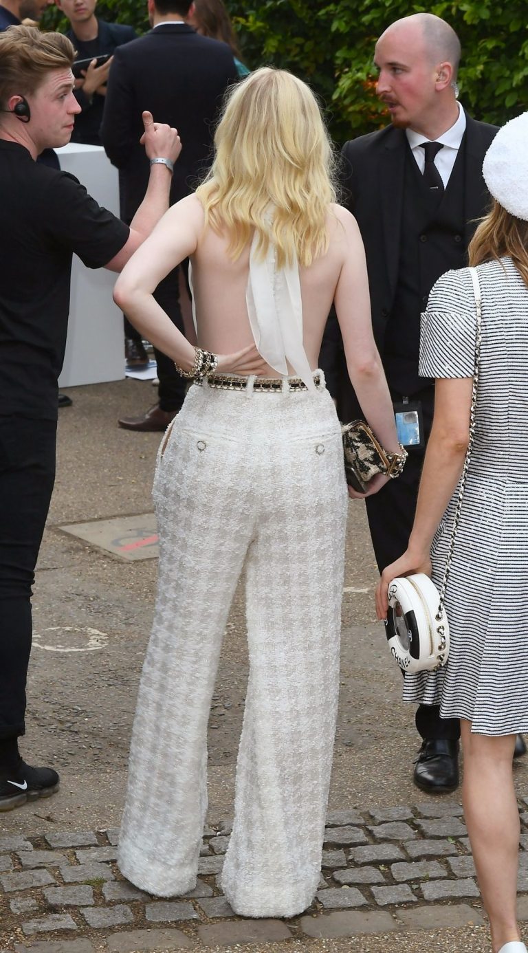 Ellie Bamber Pictures Ellie Bamber braless boobs while wearing basically a scarf as a top showing side boob cleavage.