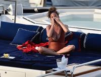 Chrissy Teigen sexy cleavage and ass in a swimsuit with her husband John Legend seen by paparazzi.

