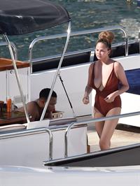 Chrissy Teigen sexy cleavage and ass in a swimsuit with her husband John Legend seen by paparazzi.
