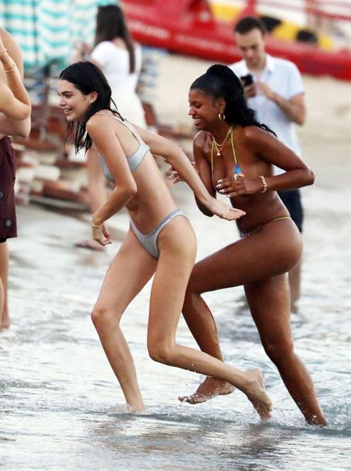 Kendall Jenner Bikini Pictures Kendall Jenner sexy ass in a thong bikini seen by paparazzi in the water at the beach.