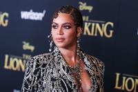 Beyonce braless boobs and areola peek showing off nice cleavage on the red carpet for the premiere of  The Lion King .






