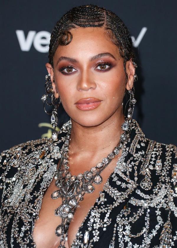 Beyonce braless boobs and areola peek showing off nice cleavage on the red carpet for the premiere of  The Lion King .






